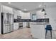 Modern kitchen with white cabinetry, stainless steel appliances, and dark backsplash at 3012 Penelope Loop, Kissimmee, FL 34746