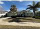 Single-story house with a green facade, attached garage, and palm trees at 3027 Eagle Lake Dr, Orlando, FL 32837