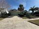 Landscaped yard, attached garage, and two-story house at 3027 Eagle Lake Dr, Orlando, FL 32837