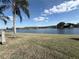 Scenic lakefront property with lush green grass at 3027 Eagle Lake Dr, Orlando, FL 32837