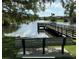 Serene lake view with a dock and bench, perfect for relaxing at 3027 Eagle Lake Dr, Orlando, FL 32837