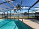 Relaxing pool and spa with a screened enclosure and lake view at 3027 Eagle Lake Dr, Orlando, FL 32837