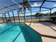 Inviting pool area with screened enclosure overlooking a lake at 3027 Eagle Lake Dr, Orlando, FL 32837