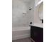 Elegant bathroom with marble tile and a black vanity at 313 Bass Ct, Kissimmee, FL 34759