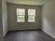 Bright bedroom with gray vinyl plank flooring and large windows at 313 Bass Ct, Kissimmee, FL 34759