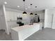 Modern kitchen with white cabinets, large island, and pendant lighting at 313 Bass Ct, Kissimmee, FL 34759