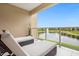 Relaxing balcony overlooking a lake with lounge chairs at 3224 Brasilia Ave # 3224, Kissimmee, FL 34747