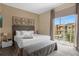 King-size bed, neutral decor, and private balcony at 3224 Brasilia Ave # 3224, Kissimmee, FL 34747