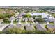 An aerial view of a neighborhood with houses and a small lake, surrounded by mature trees and well-maintained landscaping at 337 Fern Lake Dr, Orlando, FL 32825