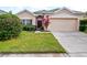 Tan house with a two-car garage and manicured lawn at 337 Fern Lake Dr, Orlando, FL 32825