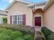 Front entry with burgundy door and well-maintained landscaping at 337 Fern Lake Dr, Orlando, FL 32825