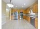 Bright kitchen features stainless steel appliances and wood cabinets at 337 Fern Lake Dr, Orlando, FL 32825