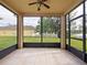 Screened patio with tile flooring overlooking the backyard and pond with views of a white picket fence at 337 Fern Lake Dr, Orlando, FL 32825