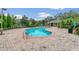 Community pool with brick patio and lounge chairs at 337 Fern Lake Dr, Orlando, FL 32825