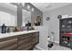 Bathroom with double vanity, large mirror, and storage cabinet at 3717 Jericho Dr, Casselberry, FL 32707