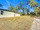 Backyard view of home with grassy area and trees at 413 Ruby Ave, Deland, FL 32724