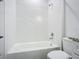 Simple bathroom with white subway tile and a shower/tub combo at 413 Ruby Ave, Deland, FL 32724