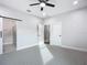 Spacious bedroom with ceiling fan and grey carpet at 413 Ruby Ave, Deland, FL 32724