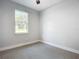 Simple bedroom with grey carpet and a window at 413 Ruby Ave, Deland, FL 32724