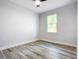 Light bedroom with wood-look flooring and ceiling fan at 413 Ruby Ave, Deland, FL 32724