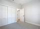 Bedroom with white closet doors and additional door at 413 Ruby Ave, Deland, FL 32724