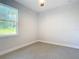 Bright bedroom with carpeted floor and large window at 413 Ruby Ave, Deland, FL 32724