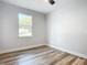 Simple bedroom with wood-look flooring and window at 413 Ruby Ave, Deland, FL 32724