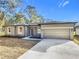 New construction home with gray exterior, two-car garage, and landscaping at 413 Ruby Ave, Deland, FL 32724