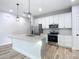 Modern kitchen with stainless steel appliances and granite countertops at 413 Ruby Ave, Deland, FL 32724