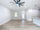 Open concept living room and kitchen with wood-look floors at 413 Ruby Ave, Deland, FL 32724