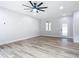 Open concept living room and kitchen with wood-look floors at 413 Ruby Ave, Deland, FL 32724