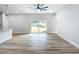 Bright living room with sliding glass doors and wood-look floors at 413 Ruby Ave, Deland, FL 32724