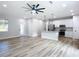 Open concept living room and kitchen with wood-look floors at 413 Ruby Ave, Deland, FL 32724