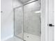 Large walk-in shower with marble tile and glass enclosure at 413 Ruby Ave, Deland, FL 32724