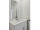 Bathroom featuring a white vanity with quartz countertop and a large mirror at 4537 Sidesaddle Trl, St Cloud, FL 34772