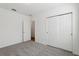 Bright bedroom with neutral carpet, white walls, and a closet with sliding doors at 4537 Sidesaddle Trl, St Cloud, FL 34772