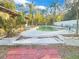 Kidney-shaped pool with surrounding patio and landscaping at 5240 N Powers Dr, Orlando, FL 32818