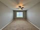 Large bedroom with ceiling fan and window at 617 Finn Ave, Auburndale, FL 33823