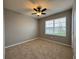 Well-lit bedroom featuring neutral wall paint and plush carpeting at 617 Finn Ave, Auburndale, FL 33823