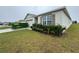 House exterior view with landscaping and a dumpster at 617 Finn Ave, Auburndale, FL 33823