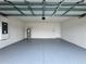 Attached garage with painted floor and extra space at 617 Finn Ave, Auburndale, FL 33823