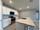 Modern kitchen with stainless steel appliances and island at 617 Finn Ave, Auburndale, FL 33823