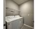 Laundry room with washer, dryer, and overhead shelving at 617 Finn Ave, Auburndale, FL 33823