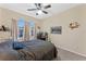 Bedroom with large windows, ceiling fan, and workspace at 622 Glastonbury Dr, Orlando, FL 32825