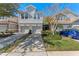 Two-story townhome with gray exterior, two-car garage, and landscaped front yard at 622 Glastonbury Dr, Orlando, FL 32825