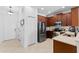 Kitchen with stainless steel appliances and dark wood cabinets at 622 Glastonbury Dr, Orlando, FL 32825