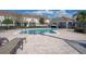 Community pool with a covered patio and lounge chairs at 622 Glastonbury Dr, Orlando, FL 32825