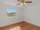 Well-lit bedroom with wood-look floors and a window at 7852 Murcott Cir, Orlando, FL 32835