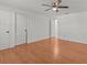 Spacious bedroom with wood-look floors and ceiling fan at 7852 Murcott Cir, Orlando, FL 32835