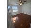 Bright bedroom with wood laminate flooring and ceiling fan at 7852 Murcott Cir, Orlando, FL 32835